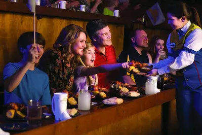 Family eating four course feast at Dolly Parton_s Stampede